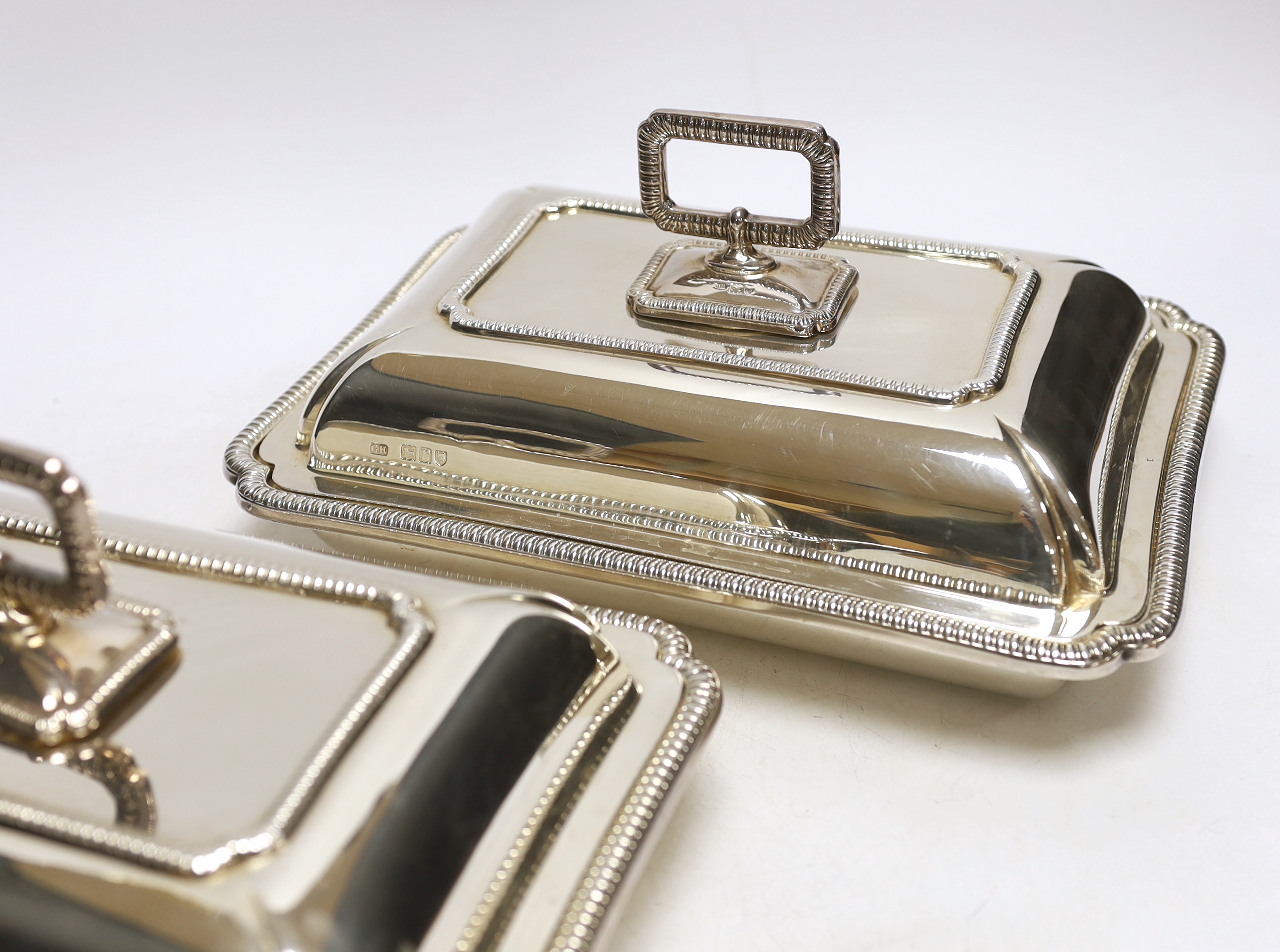 A pair of George V silver rectangular entrée dishes with covers and handles, by George Howson